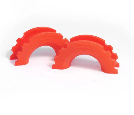 Two fluorescent orange Daystar D-Ring Shackle Isolators, semi-circular notched shackle isolators