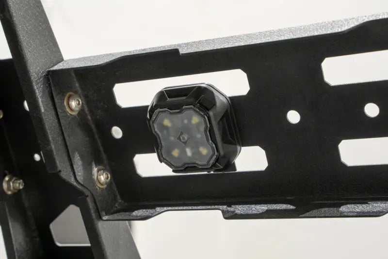 Black LED rock light mounted on metal rack, perfect for RV parts & accessories and powersports