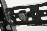 Black LED rock light mounted on metal rack, perfect for RV parts & accessories and powersports