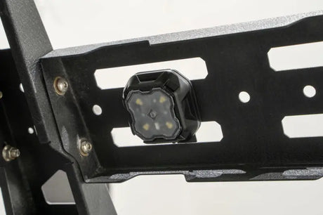 Black LED rock light mounted on metal rack, perfect for RV parts & accessories and powersports