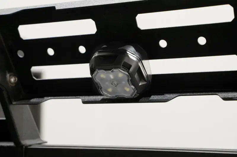 Black LED rock light mounted on metal rack for RV parts & accessories or powersports