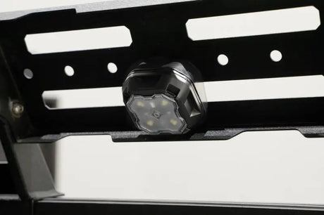 Black LED rock light mounted on metal rack for RV parts & accessories or powersports