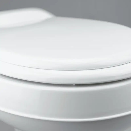 Dometic 300 Series RV Toilet with Easy Clean Design features a sleek, white finish and a convenient pedal flush control.