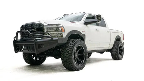 DR19-Q4462-1 Fab Fours Black Steel Elite Front bumper on a white off-road truck.