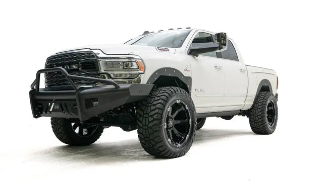 DR19-Q4462-1 Fab Fours Black Steel Elite Front bumper on a white off-road truck.
