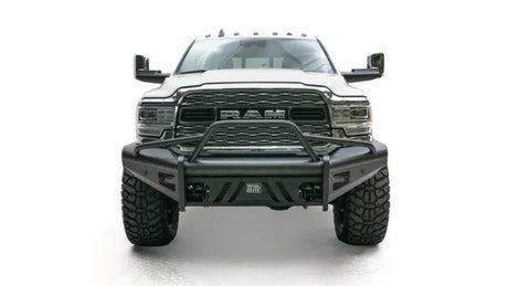 Front view of a white RAM truck equipped with a Fab Fours Black Steel Elite Front bumper, showcasing its durable and rugged black steel construction against a white background.
