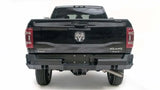 Rear view of a black Dodge Ram 2500-3500 Big Horn 4x4 with Fab Fours Premium DR19-W4451-1 bumper installation.