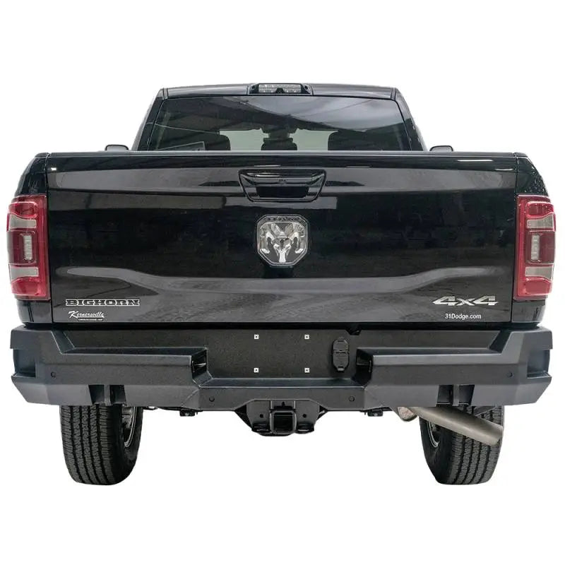 Rear view of a black 2019 Dodge Ram 2500-3500 featuring the Fab Fours DR19-W4451-1 Premium rear bumper, showcasing robust design and high-quality construction.