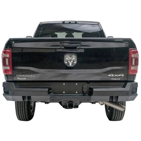 Rear view of a black 2019 Dodge Ram 2500-3500 featuring the Fab Fours DR19-W4451-1 Premium rear bumper, showcasing robust design and high-quality construction.