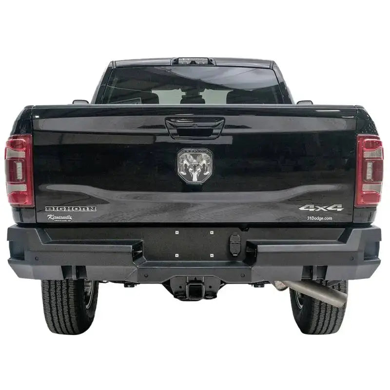 Rear view of a black 2019 Dodge Ram 2500-3500 featuring the Fab Fours DR19-W4451-1 Premium rear bumper, showcasing robust design and high-quality construction.