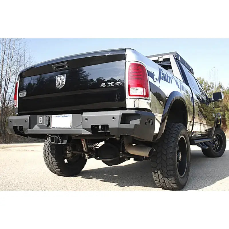 Rear view of a 2019 Dodge Ram 2500-3500 equipped with the premium Fab Fours DR19-W4451-1 bumper, showcasing rugged design and high-quality construction.