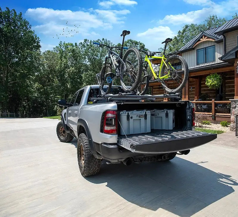 Silver pickup with bicycles and storage containers in open bed, perfect for gear strcs80 TGR