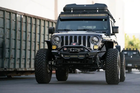 DV8 Offroad 18-23 Wrangler JL/Gladiator JT Spec Series Front Bumper on a Jeep with a Warn 12s EVO winch and mounted light bar.