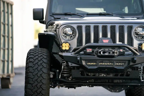 DV8 Offroad Spec Series Front Bumper on a 2018-2023 Jeep Wrangler JL/Gladiator JT, featuring high clearance design with Warn 12s EVO winch and mounting options for up to a 15-inch light bar.