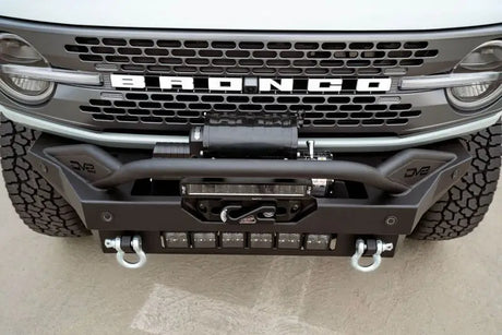 DV8 Offroad 2021+ Ford Bronco Modular Front Bumper Winch Capable with Auxiliary Light Mounts, featuring a bull bar, 13-inch light bar, and recovery mounts.