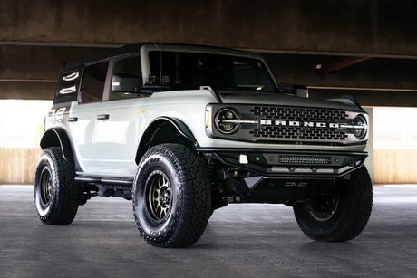 DV8 Offroad Competition Series Front Bumper on a 2021-2022 Ford Bronco, showcasing superior protection and improved approach angle with a steel skid plate.