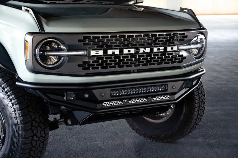 DV8 Offroad Competition Series Front Bumper on 2021-2022 Ford Bronco, featuring a low profile design with a steel skid plate and bolt-on side gussets for enhanced protection.