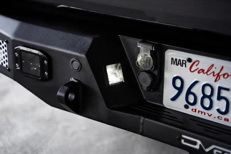 DV8 Offroad MTO Series Rear Bumper for 2021-2023 Ford F-150 showing license plate area and lighting features.
