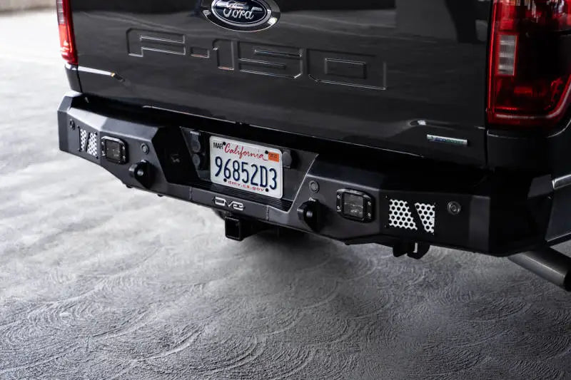 DV8 Offroad 21-23 Ford F-150 MTO Series Rear Bumper with license plate light and utility steps.