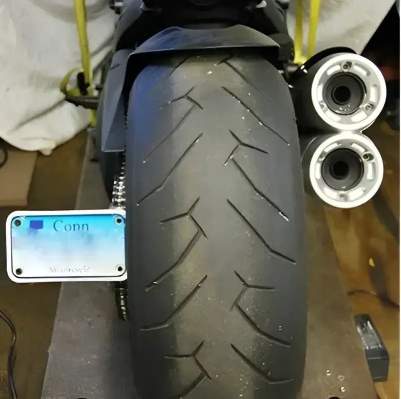 Motorcycle rear tire and exhaust with DVL-FE Fender Eliminator Duc upgrade