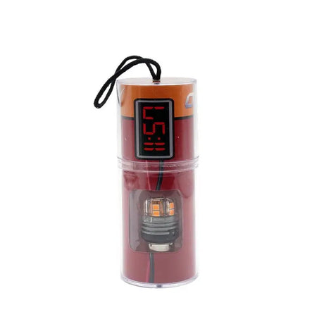 Clear cylindrical package with DYN-1157AM ODX Dynamite Series alarm clock and orange LED bulb