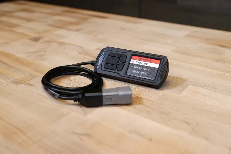 Black Dynojet Power Vision 3 device with display for Maverick Trail Sport diagnostics