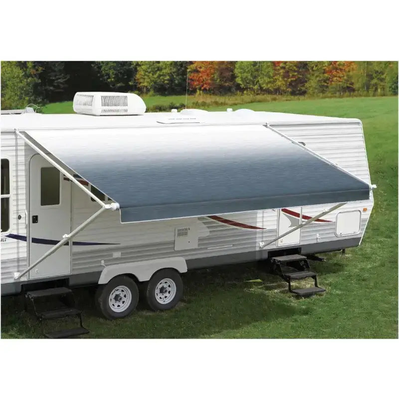 White 14' Carefree Fiesta awning attached to a travel trailer, providing shade and comfort in a grassy outdoor setting.