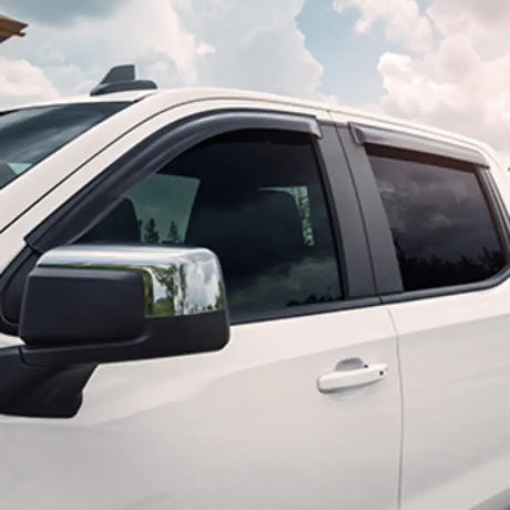 White pickup truck with chrome mirror and EGR 2019 Chevy 1500 window visors