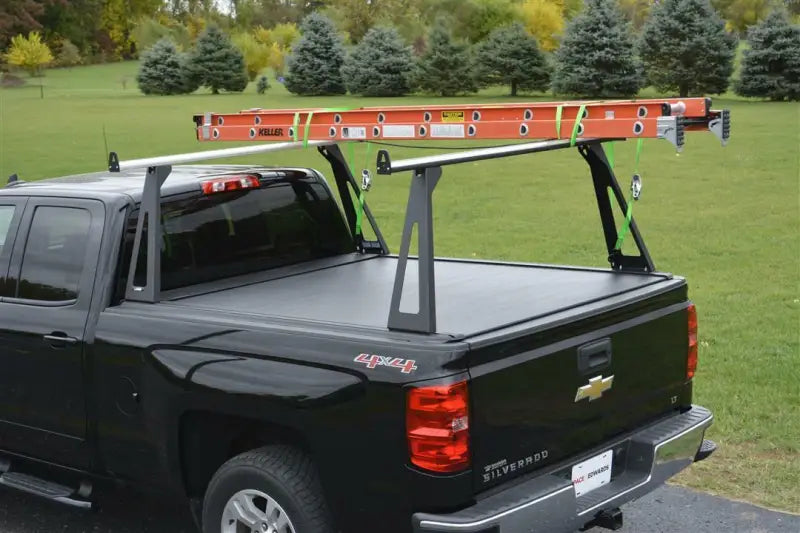 Black pickup truck with ladder rack.
