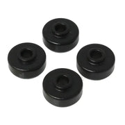 Four black cylindrical objects with a central hole, arranged in a circular pattern on a white background. The objects appear to be part of the Energy Suspension Universal Black Shock Bushing Set made by Energy Suspension, known for its use of premium polyurethane material for durability and superior performance.