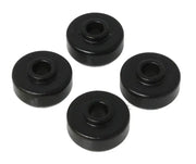 Four black cylindrical objects with a central hole, arranged in a circular pattern on a white background. The objects appear to be part of the Energy Suspension Universal Black Shock Bushing Set made by Energy Suspension, known for its use of premium polyurethane material for durability and superior performance.