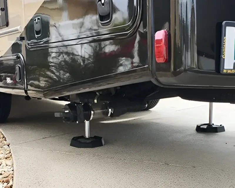 EQ7SP4 Snappad Snappad Eq Compact - 4 Pack providing stable support for equipment under a vehicle on concrete.