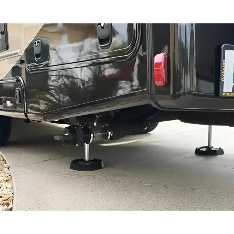 EQ7SP4 Snappad Snappad Eq Compact - 4 Pack providing stable support for equipment under a vehicle on concrete.
