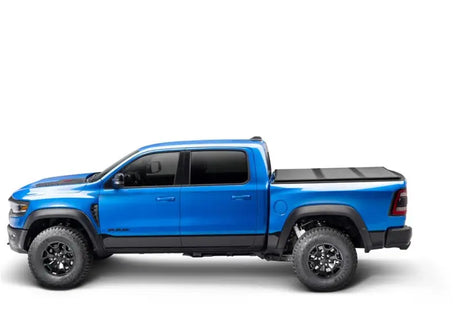 Blue Ram pickup with Solid Fold ALX bed cover on dodge ram 1500/2500/3500