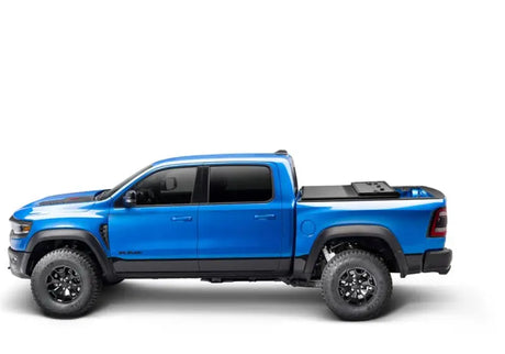 Blue Ram pickup truck with bed cover showing Solid Fold ALX on dodge ram model