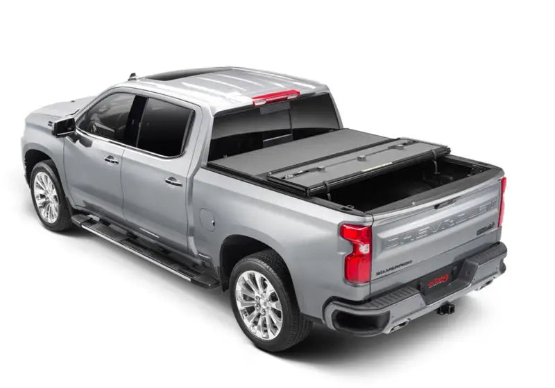 Silver pickup truck with tonneau cover using Extang Solid Fold ALX for Chevy/GMC Silverado