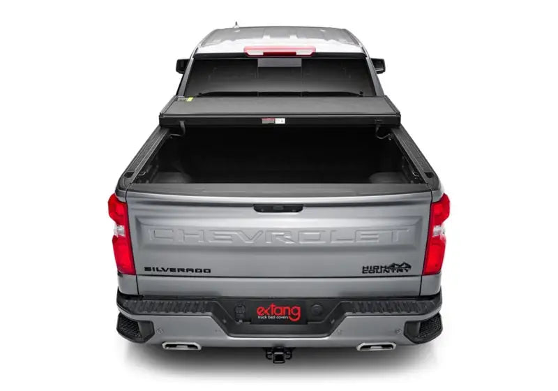 Silver pickup truck with open bed cover showcasing Extang Solid Fold ALX