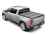 Silver pickup truck with tonneau cover featuring Extang Solid Fold ALX for Silverado/Sierra