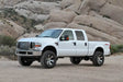 White Ford F250 Super Duty pickup with Fabtech 4in Budget System and 8 Lug wheels