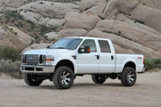 White Ford F250 Super Duty pickup with Fabtech 4in Budget System and 8 Lug wheels