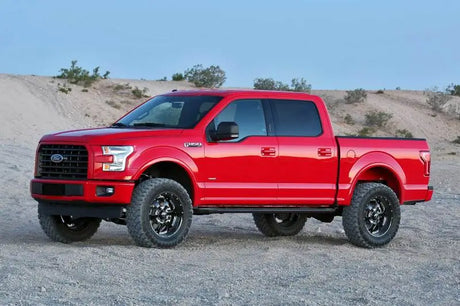 Red Ford F150 4WD with lifted suspension and black off-road wheels for 4in basic upgrade