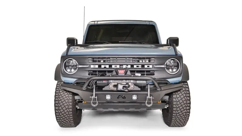 FB21-B5252-1 Fab Fours Stubby Front Bumper on a front view of a blue off-road vehicle