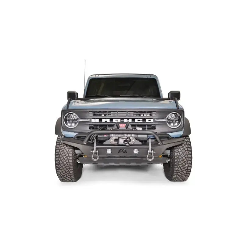 FB21-B5252-1 Fab Fours Stubby Front Bumper on a front view of a blue off-road vehicle