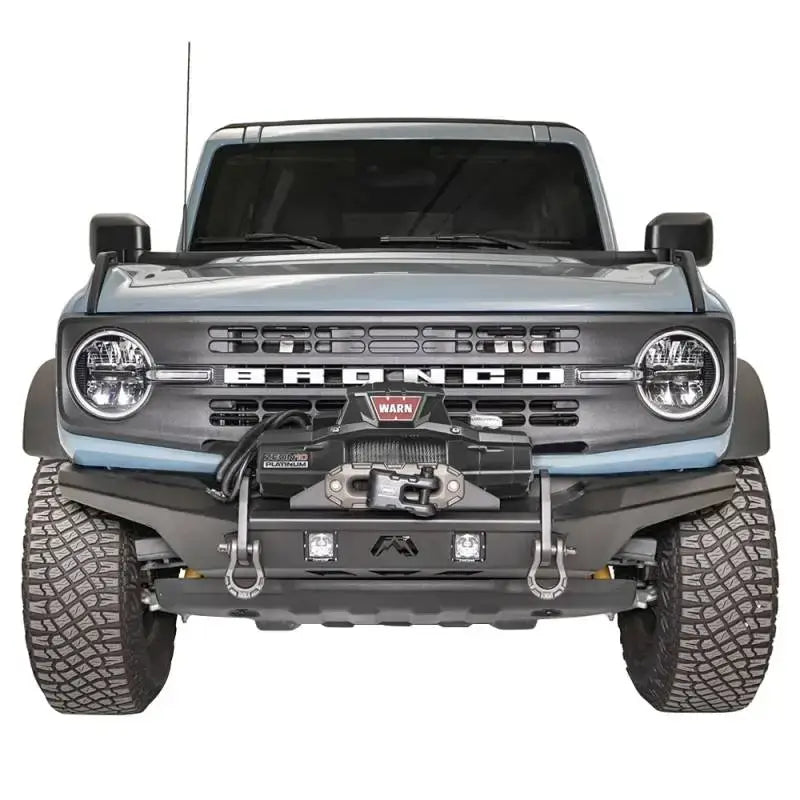 Front view of a vehicle showcasing the FB21-B5252-1 Fab Fours Stubby Front Bumper with a rugged design and high-quality construction.