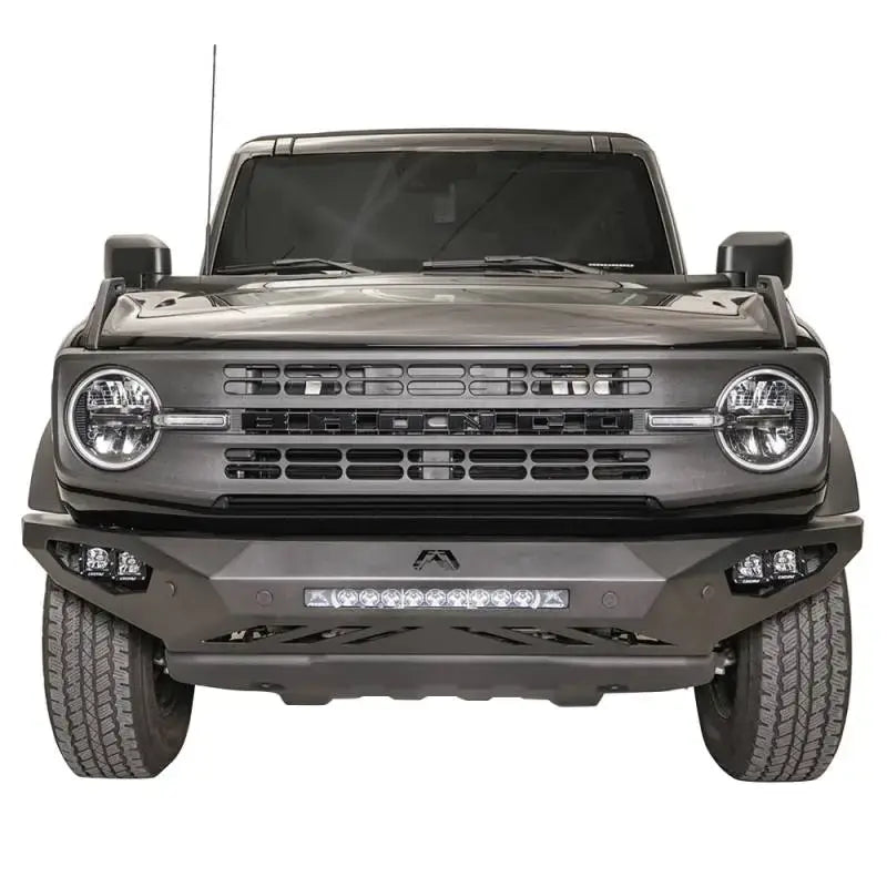 FB21-D5251-1 Fab Fours Vengeance Front Bumper mounted on a rugged, aggressive off-road vehicle, showcasing unparalleled protection and durability.