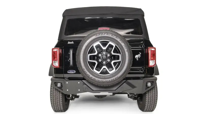 FB21-E5251-1 Fab Fours Vengeance Rear Bumper installed on a black Ford vehicle, showcasing rugged design and high-quality construction for superior rear-end protection and enhanced off-road performance.