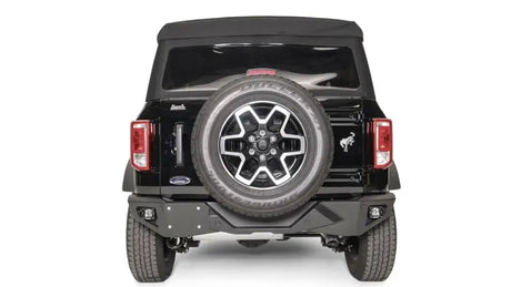 FB21-E5251-1 Fab Fours Vengeance Rear Bumper installed on a black Ford vehicle, showcasing rugged design and high-quality construction for superior rear-end protection and enhanced off-road performance.