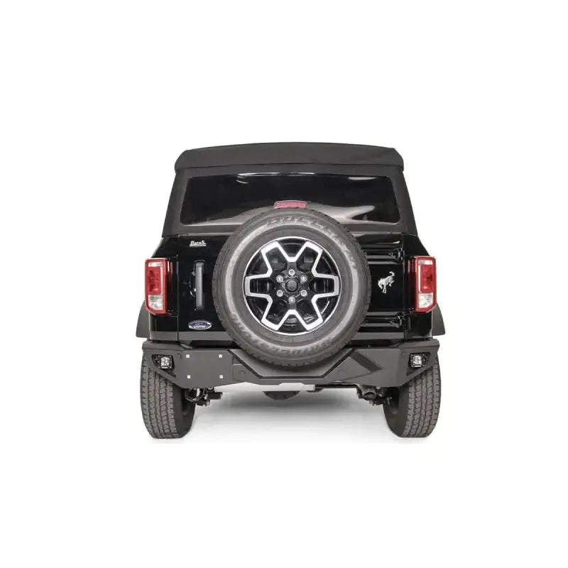 FB21-E5251-1 Fab Fours Vengeance Rear Bumper installed on a black Ford vehicle, showcasing rugged design and high-quality construction for superior rear-end protection and enhanced off-road performance.
