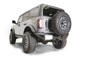 Rear view of an off-road vehicle featuring the FB21-Y5251T-1 Fab Fours Tire Carrier Bracket securely holding a rugged spare tire for adventurous journeys.