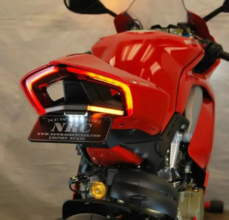 Fender Eliminator Duc with LED tail light and side mount license plate kit on a red motorcycle rear view showcasing installation and sleek design.